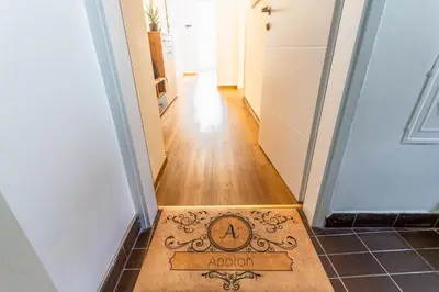a welcome mat on the floor of a hallway at Apartma Apolon II in Krško