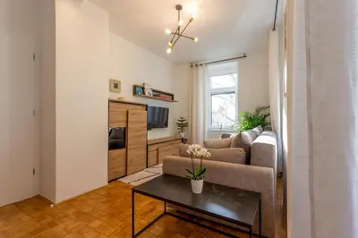 a living room with a couch and a table at Apartma Apolon II in Krško