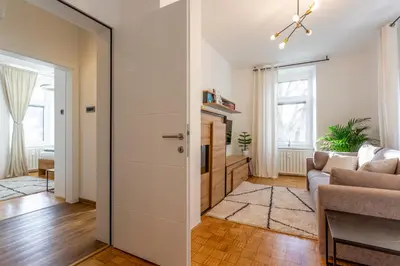 an open door to a living room with a couch at Apartma Apolon II in Krško