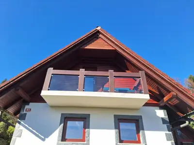a house with a balcony on top of it at Pohorje Zen Garden in Pohorje