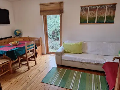 a living room with a couch and a table at Pohorje Zen Garden in Pohorje
