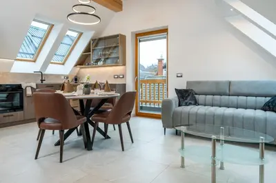 a living room with a couch and a table at Apartma pri Hrvatu in Bohinj