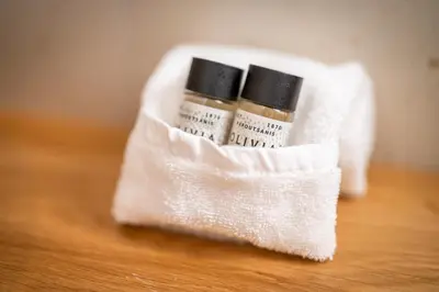 two bottles of essential oils in a white towel at Apartma pri Hrvatu in Bohinj