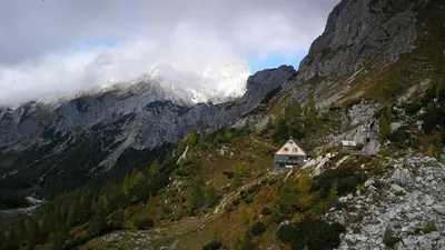 a house on the side of a mountain at Apartma pri Hrvatu in Bohinj