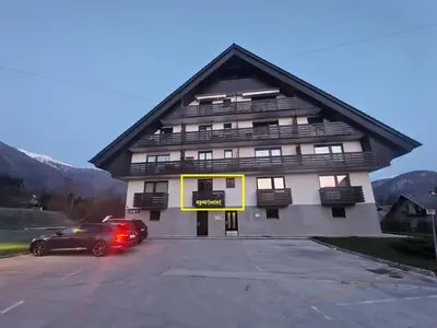 a building with a car parked in a parking lot at Bohinj Jeglič C17 in Bohinj