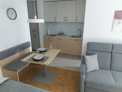 a living room with a table and a couch at Bohinj Jeglič C17 in Bohinj