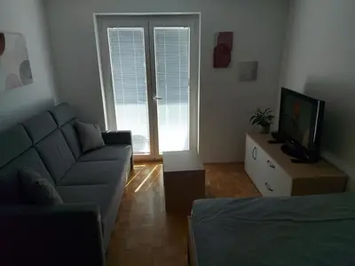 a living room with a couch and a tv at Bohinj Jeglič C17 in Bohinj