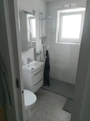 a bathroom with a sink and a toilet and a window at Bohinj Jeglič C17 in Bohinj