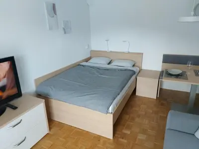 a small bedroom with a bed and a tv at Bohinj Jeglič C17 in Bohinj