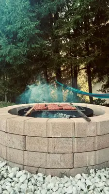 a fire pit with smoke coming out of it at Apartment River in Vitanje
