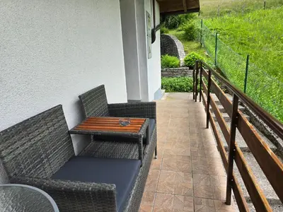 a patio with two chairs and a table on a balcony at Apartments Denis in Tolmin