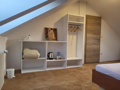 a bedroom with white shelves and a door at Kmečka Vila in Višnja Gora