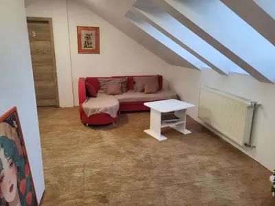 a living room with a couch and a table at Kmečka Vila in Višnja Gora
