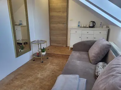 a living room with a couch and a table at Kmečka Vila in Višnja Gora