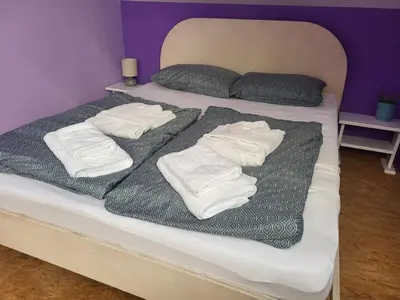 a bed with white towels on top of it at Kmečka Vila in Višnja Gora
