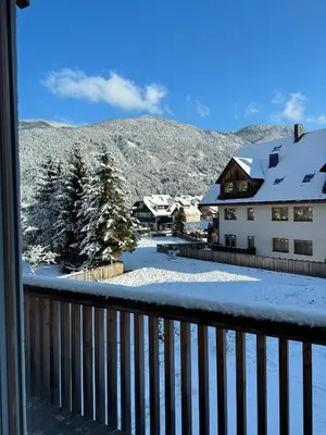 a view from a balcony of a house with snow at Steblaj apartments Park in Kranjska Gora