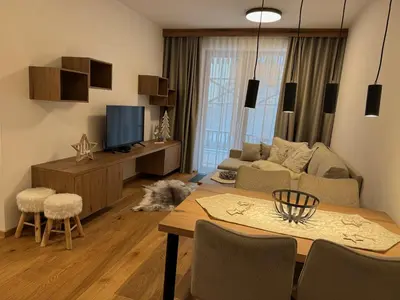 a living room with a dog laying on the floor at Steblaj apartments Park in Kranjska Gora