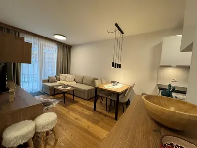 a living room with a couch and a table at Steblaj apartments Park in Kranjska Gora