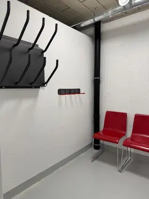 a room with two red chairs and a wall at Steblaj apartments Park in Kranjska Gora