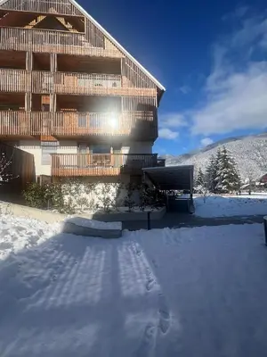 a building with snow in front of it at Steblaj apartments Park in Kranjska Gora
