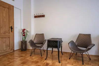 a room with two chairs and a table with a radio at OH Apartments & Rooms in Ljubljana
