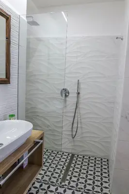 a bathroom with a shower with a sink and a toilet at OH Apartments & Rooms in Ljubljana