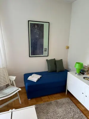 a living room with a blue couch and a chair at Lotti's Apartment in Kranjska Gora
