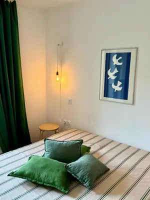 a bedroom with a bed with two green pillows at Lotti's Apartment in Kranjska Gora