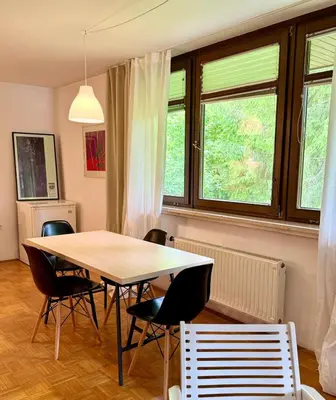 a dining room table and chairs in a room at Lotti's Apartment in Kranjska Gora