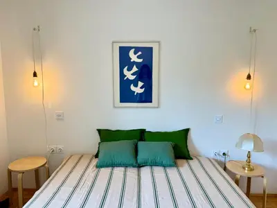 a bedroom with a bed with green pillows at Lotti's Apartment in Kranjska Gora