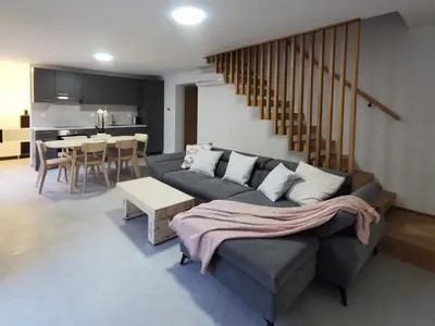 a living room with a couch and a table at Vila Perunika in Bohinj