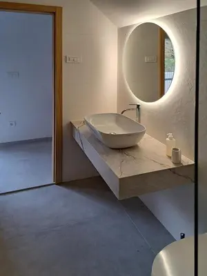 a bathroom with a sink and a mirror on a counter at Vila Perunika in Bohinj
