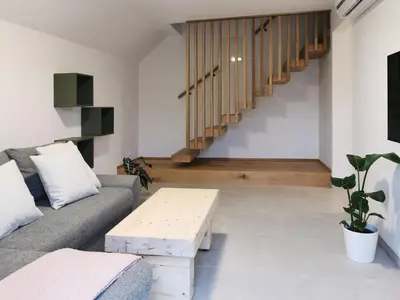 a living room with a couch and a coffee table at Vila Perunika in Bohinj