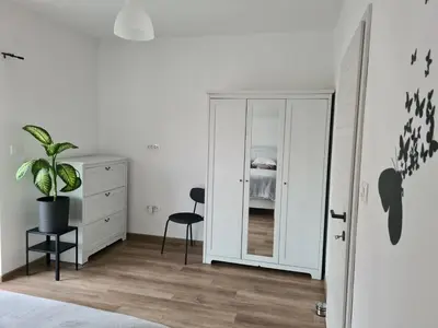 a bedroom with a dresser and a mirror at Maya-K apartment near city center in Ljubljana
