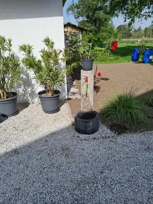 a garden with potted plants and a water fountain at Maya-K apartment near city center in Ljubljana