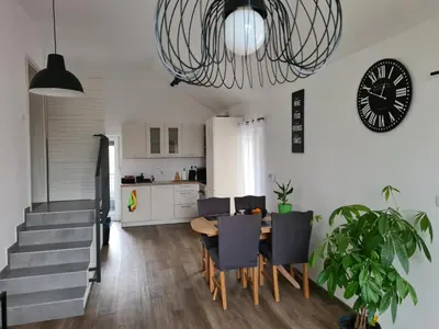 a dining room and kitchen with a table and chairs at Maya-K apartment near city center in Ljubljana