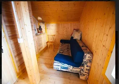 a small room with a bed in a cabin at Gorska koča Krvavec in Cerklje na Gorenjskem