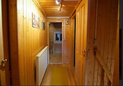a hallway in a log cabin with wooden walls at Gorska koča Krvavec in Cerklje na Gorenjskem