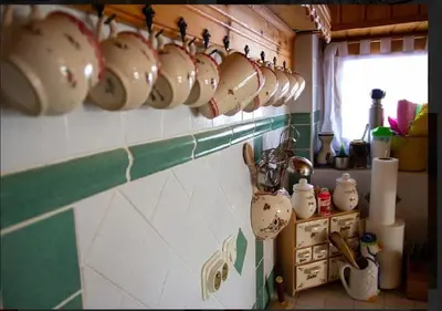 a bunch of coffee cups hanging on a wall at Gorska koča Krvavec in Cerklje na Gorenjskem