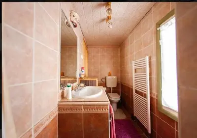a bathroom with a sink and a toilet at Gorska koča Krvavec in Cerklje na Gorenjskem