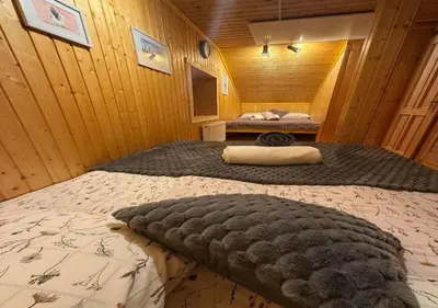a bedroom with a large bed in a room at Gorska koča Krvavec in Cerklje na Gorenjskem