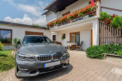 a car parked in front of a house at Apartments Wojcicky in Bovec