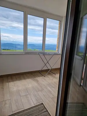 a room with three windows and a floor at Apartmaji Pr Ambružarju in Cerklje na Gorenjskem