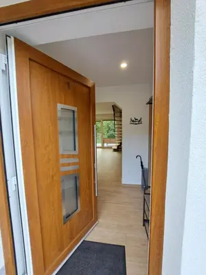 a door leading into a room with a hallway at Apartments Zlati Rog in Kranjska Gora