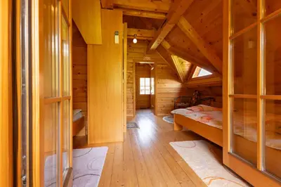 a room with two beds in a wooden cabin at Apartma Brunarca in Borovnica