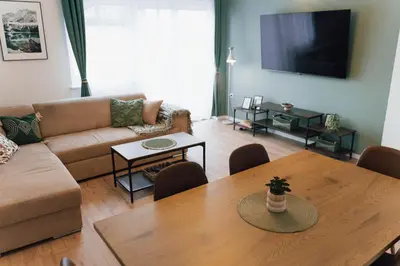 a living room with a couch and a table at Vista Apartment in Sveta Trojica v Slovenskih Goricah