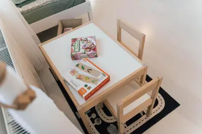 a small table and chair with books on it at Vista Apartment in Sveta Trojica v Slovenskih Goricah
