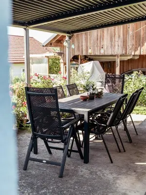 a black table and chairs on a patio at Vista Apartment in Sveta Trojica v Slovenskih Goricah