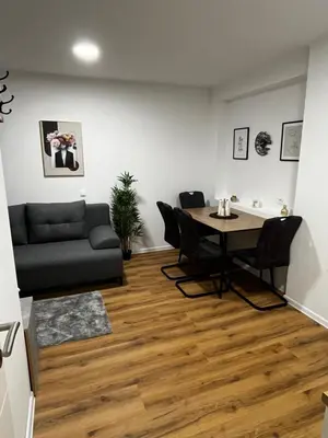 a living room with a table and a couch at Apartmaji MAS 2 in Ljubljana
