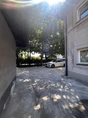 a garage with a car parked next to a building at Apartmaji MAS 2 in Ljubljana